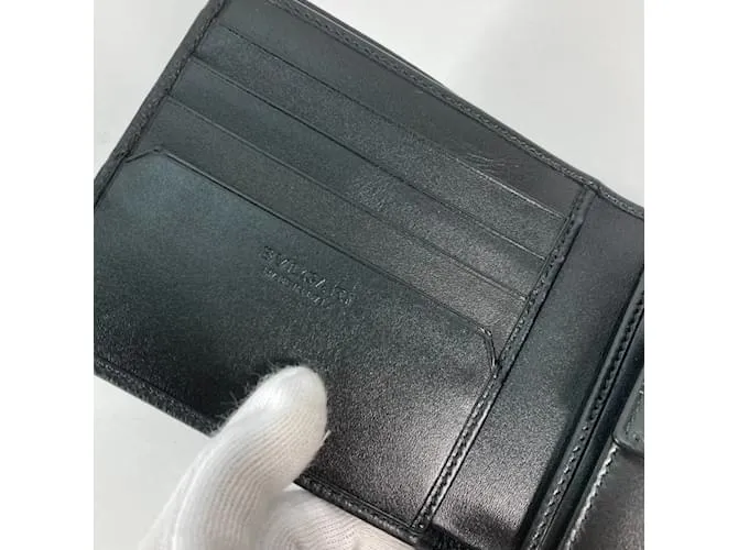 Bulgari Billetera bi-fold de cuero negro Bvlgari 