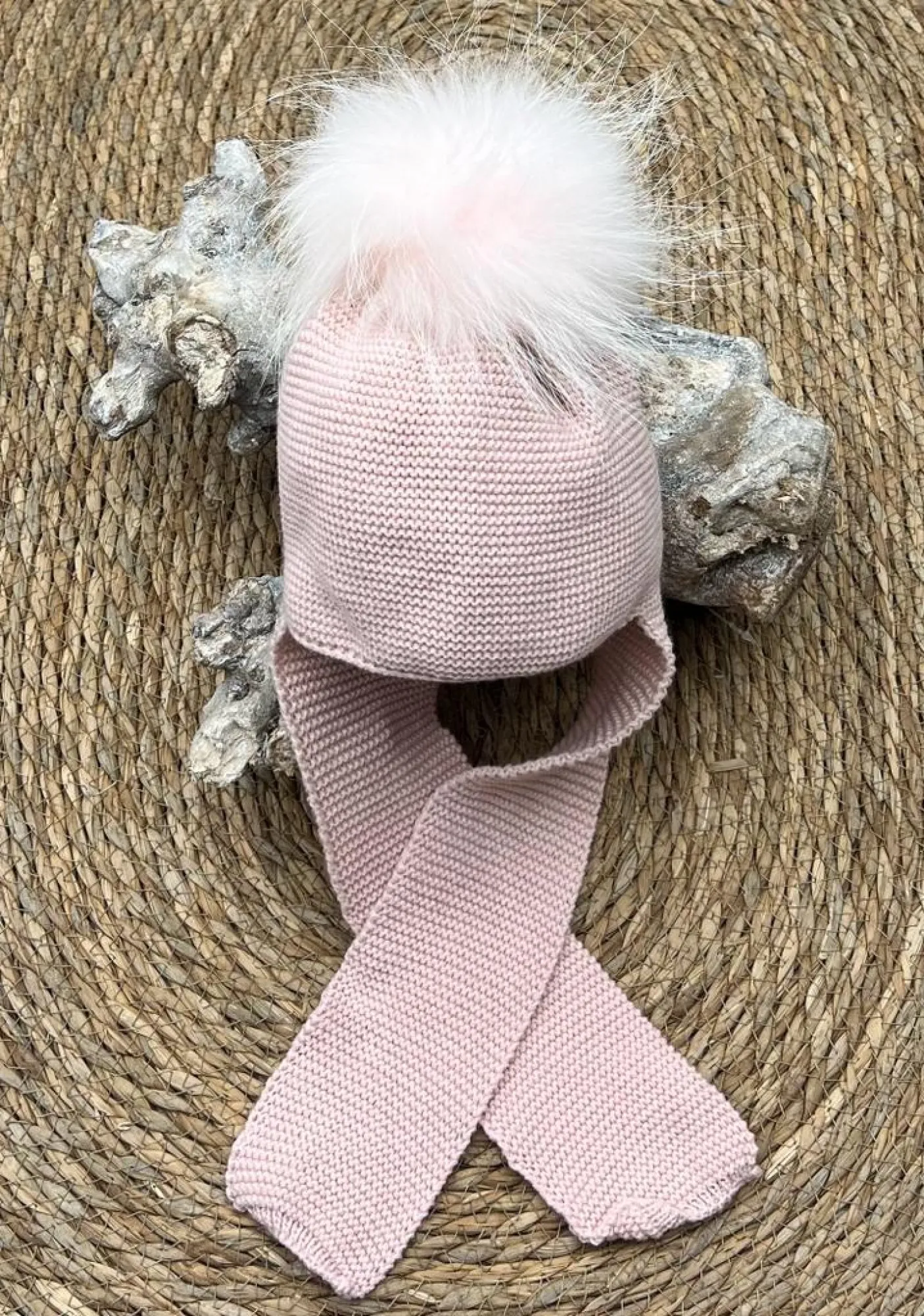 Wool hat with pom pom and scarf attached to the hat